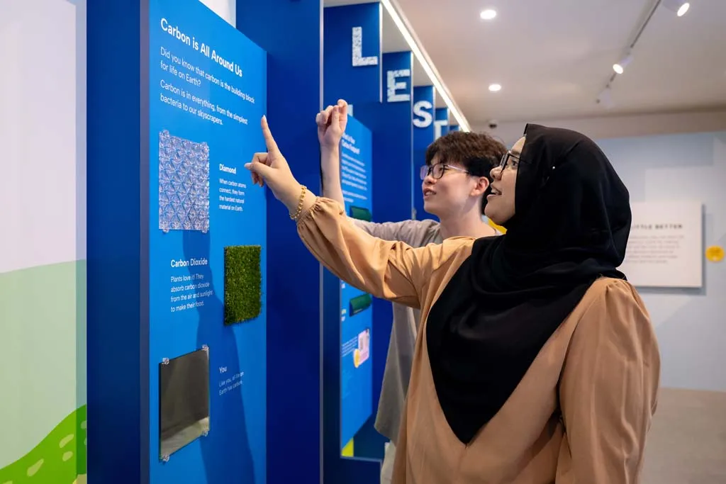 Visitors participating in a hands-on carbon learning activity
